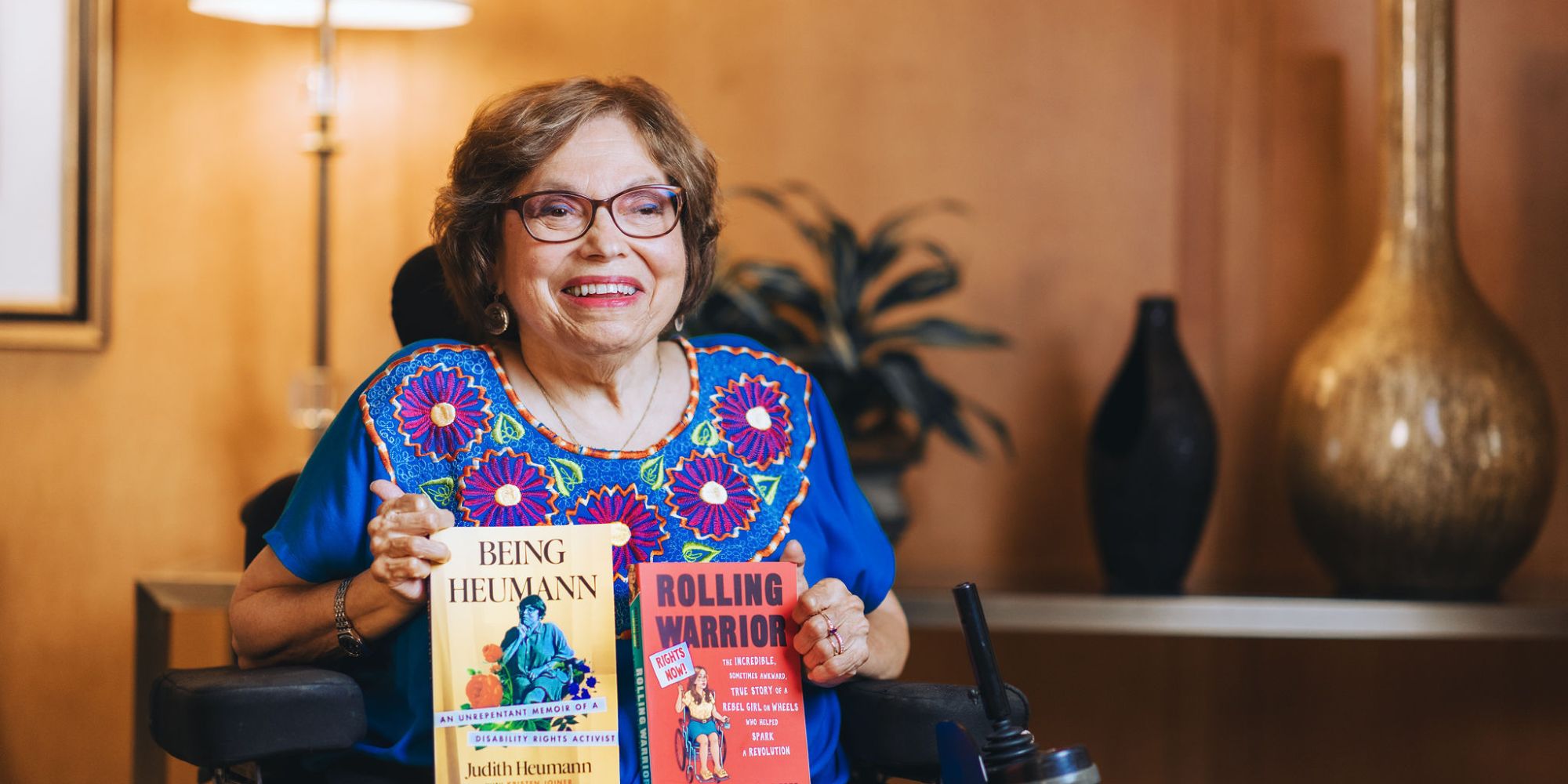 Judy Heumann with her published books on disability rights